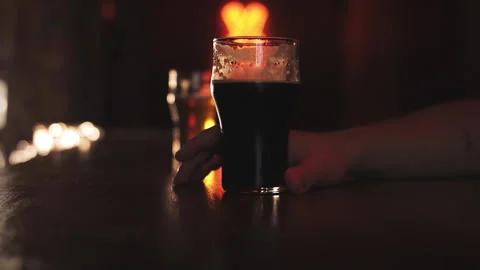 Two men drink beer in a bar Stock Footage 239790229