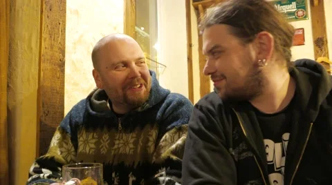 Two men drinking beer in a bar and having fun. 4K UHD Stock Footage 61894475