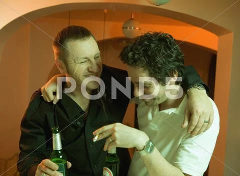 Two men drinking beer at a bar Stock Photos
