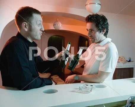 Two men drinking beer in a bar Stock Photos