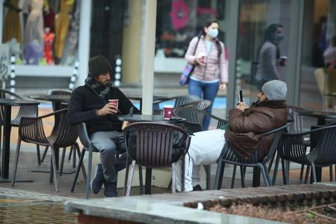 Two men drinking coffee outside Stock Photos