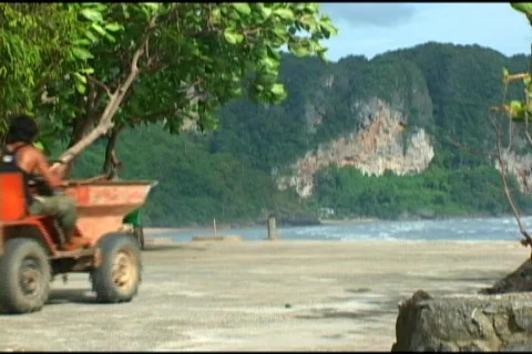 Two Men Driving A Tractor Down The Beach 스톡 동영상 511800