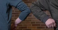 Two Men Elbow Bump As An Alternative Greeting Stock Footage