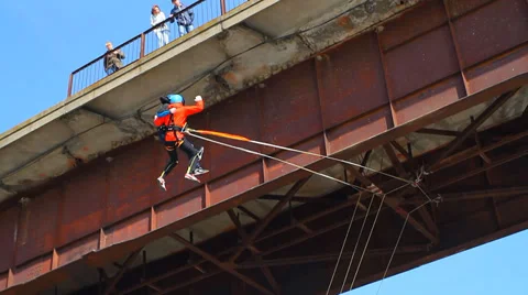 Two men embracing jump off a bridge Stock Footage 37220467
