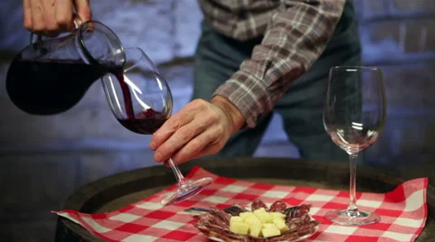 Two men enjoying home made red wine and snack in a cellar. Stock Footage 45169338