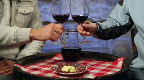 Two men enjoying home made red wine and snack in a cellar. Stock Footage 45170595