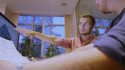 Two men with enthusiasm discuss the project plan of construction of the house Stock Footage 58015193