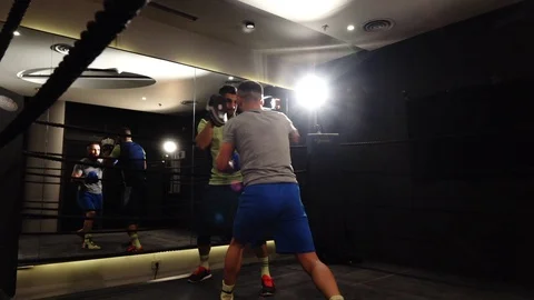Two men exercising inside a box ring in slow motion Stock Footage 101212756