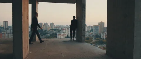 Two men in expensive suits meet in high-rise abandoned building. Stock Footage 139837998