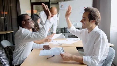 Two men express joy after solving their problem during a collaborative team Stock Footage 335733075