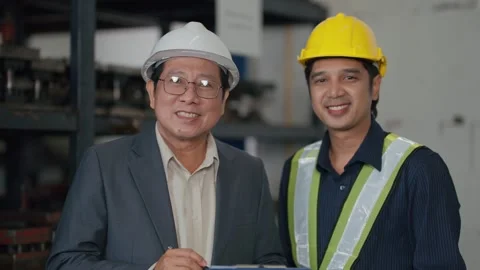 Two men in a factory setting 動画素材 341650917