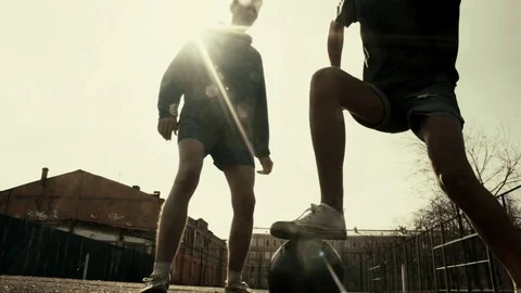 Two men fight over control of ball with foul during a football game slow motion Video stock 74517187