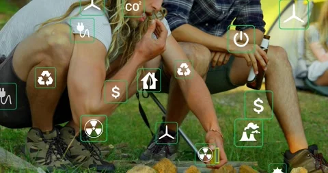 Two men at fire pit, left man taking lighter, sparking tinder for warmth, energy Stock Footage 334182546