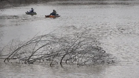 Two men fish from kayaks on a river 4K Stock Footage 102108152