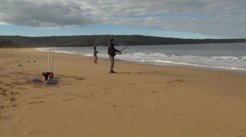Two men fishing from a beach Stock Footage 37353700