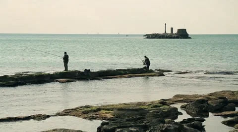 Two men fishing on a dock Stock Footage 57312147