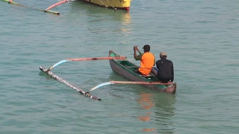 Two Men Floating In A Traditional Indonesian Boat Stock Footage 85336996