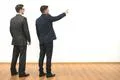 The two men gesture on the white wall background Photo