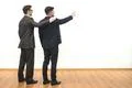 The two men gesture on the white wall background Photo