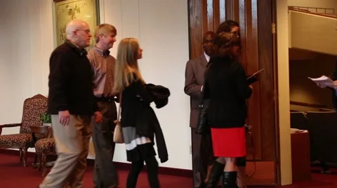 Two men giving welcome to guests at church Stock-Footage 46463979