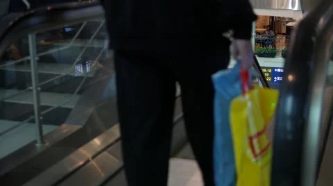 Two men going down an escalator in airport 스톡 동영상 62589903