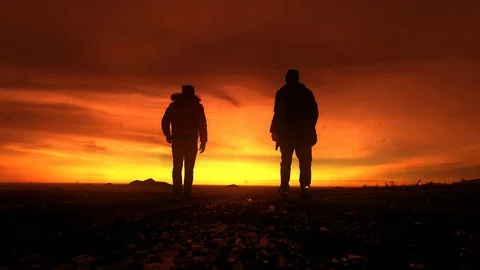 Two men going into the sunset, mountains Stock Footage 102613900
