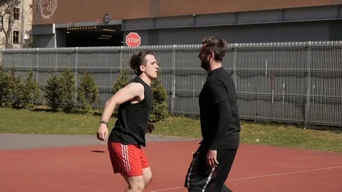 Two men guys having fun on a street basketball ground Video stock 88357989