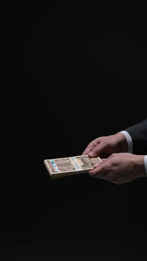 Two men hands exchanging a bundle of cash in a dark transaction Stock Footage 336766038
