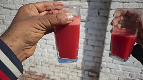 Two men hands smashing fresh carrot juice with celebration slow motion 480fps Stock Footage 265537433