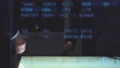 The two men handshake near a display on the hologram background. slow motion 4k or 4k+ Resolution