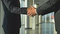 The two men handshake in the office hall. slow motion 4k or 4k+ Resolution