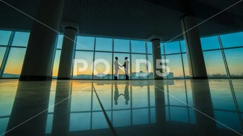 The two men handshake in the office on panoramic window background Stock Photos