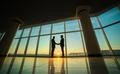 The two men handshake in the office on the sunset background Photo
