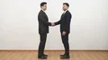 The two men handshake on the white wall background 4k or 4k+ Resolution