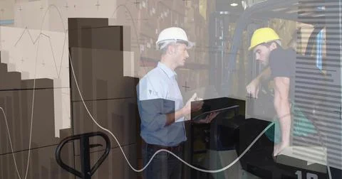 Two men in hardhats inspecting tablet and discussing stock in warehouse, with Stock Photos