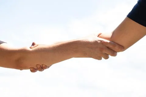 Two men held out their hands to each other as a sign of friendship and gree.. Stock Photos