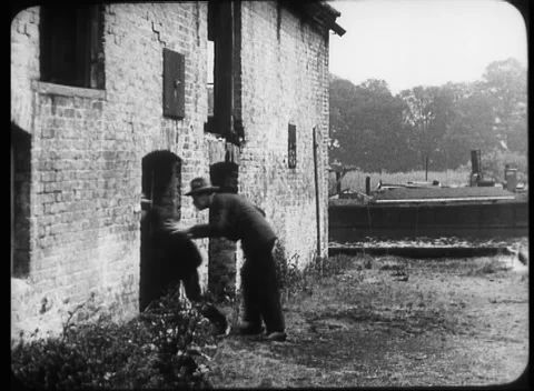 Two men hiding in old pub building and running away, United Kingdom, 1923 Stock Footage 172219644