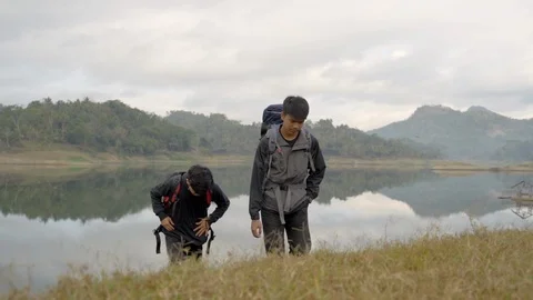 Two men hiking in mountain Stock Footage 115055833