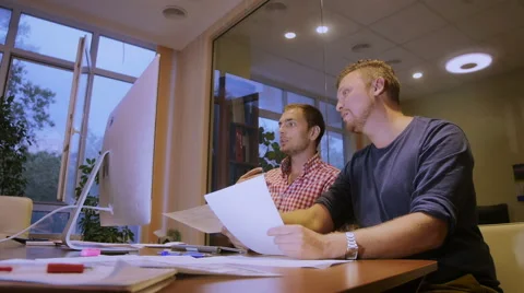 Two men hold plans of projects in hand and discuss it Stock Footage 58015835