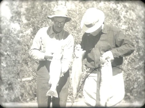 Two Men holding caught fish - Vintage 1930s Stock Footage 77810034