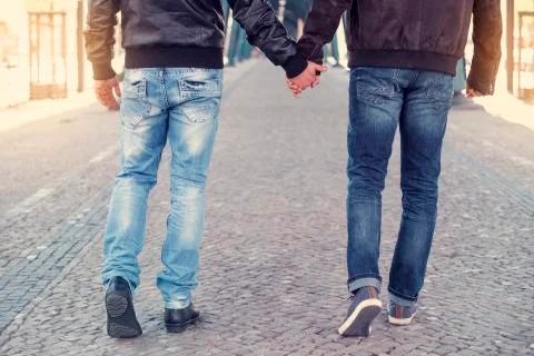 Two men holding hands Stock Photos
