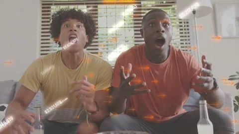 Two men holding popcorn, watching live match, reacting to goal, overlays Video stock 337236433