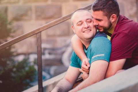 Two men hugging each other on a sunny day Stock Photos
