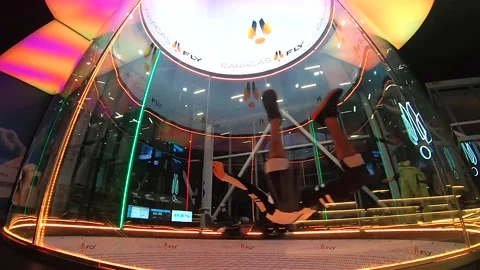 Two men inside a wind tunnel skydiving chamber Vidéo 224342948