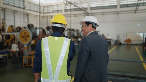 Two men inspect heavy machinery together Stock Footage 341651625