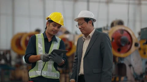 Two men inspect heavy machinery together Stock Footage 341651744