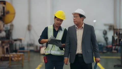 Two men inspect heavy machinery together Stock Footage 341651787