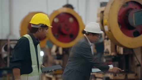Two men inspect heavy machinery together Stock Footage 341653218