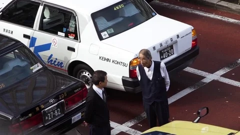 Two men interacting with each other in parking space Stock Footage 79444673