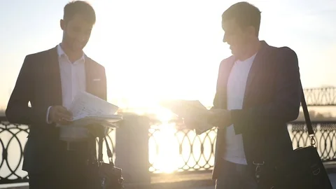 Two men in jackets are negotiating, cursing and throwing documents and papers. Stock Footage 114601419